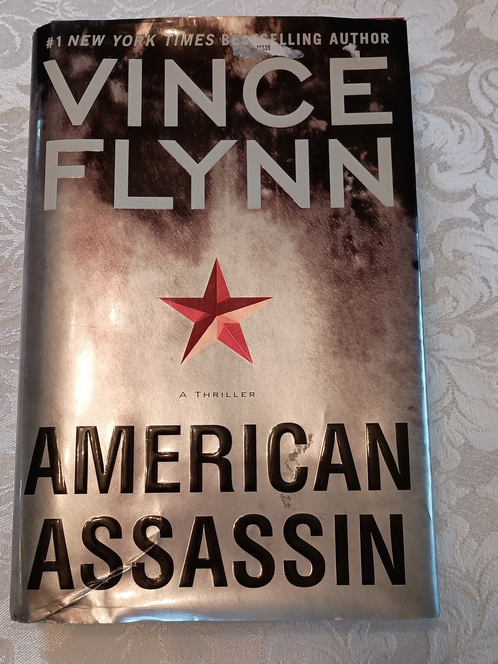 American Assassin Hardcover - Silver with Red Star